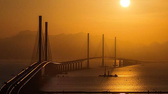 An aerial drone photo taken on Dec. 4, 2024 shows a view of Gaolan Port Bridge (with twin main towers on the left) and Huangmao Sea Channel Bridge (with three main towers on the right) in south China's Guangdong Province. (Xinhua/Liu Dawei)