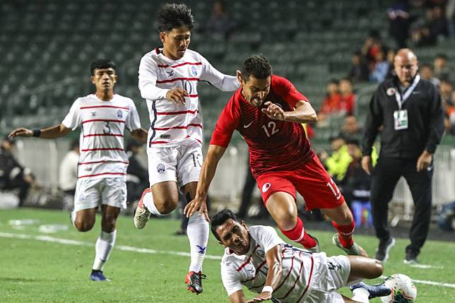 Hong Kong’s Giovane Alves skips over a Cambodian defender during their World Cup qualifier at Hong Kong Stadium. Photo: May Tse