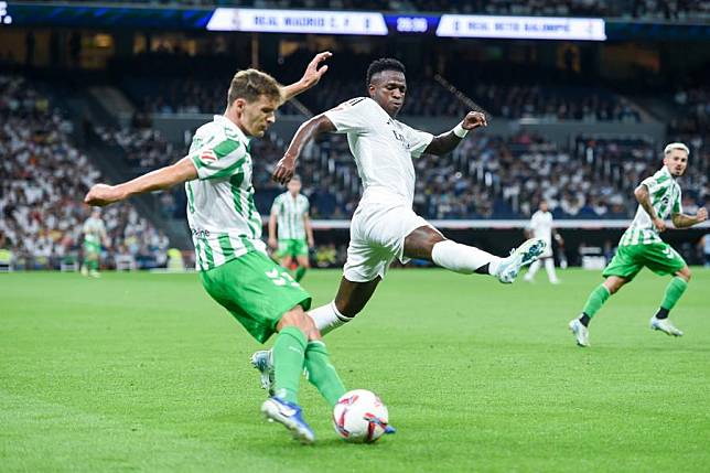 Real Madrid player Vinicius Jr. &reg; vies with Real Betis player Diego Llorente during La Liga football match between Real Madrid and Real Betis, in Santiago Bernabeu stadium, Madrid, Spain, Sept. 1, 2024. (Photo by Gustavo Valiente/Xinhua)