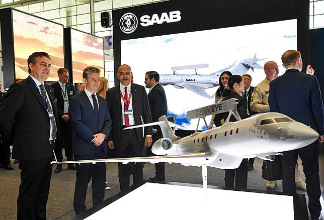 Visitors look at a model of the Global Eye plane at Milipol Qatar 2024, an international event for homeland security and civil defense, at Doha Exhibition and Convention Center in Doha, Qatar, on Oct. 29, 2024. (Photo by Nikku/Xinhua)