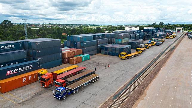 This aerial photo taken on Aug. 9, 2022 shows trucks for cross-border goods transportation at Vientiane South Station of China-Laos Railway in Laos. (Photo by Kaikeo Saiyasane/Xinhua)