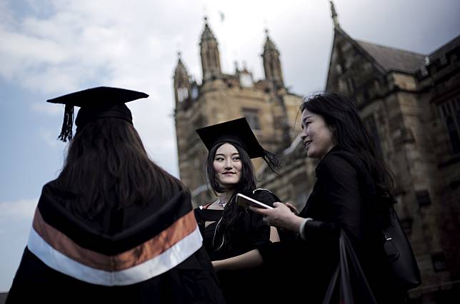 FILE PHOTO: A university student wears her mortar hat following her graduation ceremony from the School of Commerce at the University of Sydney in Australia