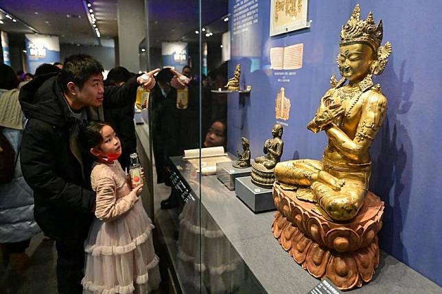 Visitors view exhibits at a museum in Urumqi, capital of northwest China's Xinjiang Uygur Autonomous Region, Feb. 14, 2024. (Xinhua/Ding Lei)