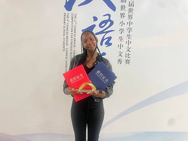 Mirriam Wambui, winner of the Chinese Bridge competition in Kenya, poses with award certificates in Tianjin City, China, October 2024. (Courtesy of Charity Atunga, Chrispinus Omar/Handout via Xinhua)