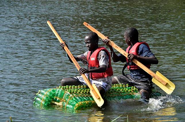 People compete in a recycled plastic boat race in Kaazi, Wakiso District in Uganda, on Feb. 22, 2025. (Photo by Nicholas Kajoba/Xinhua)