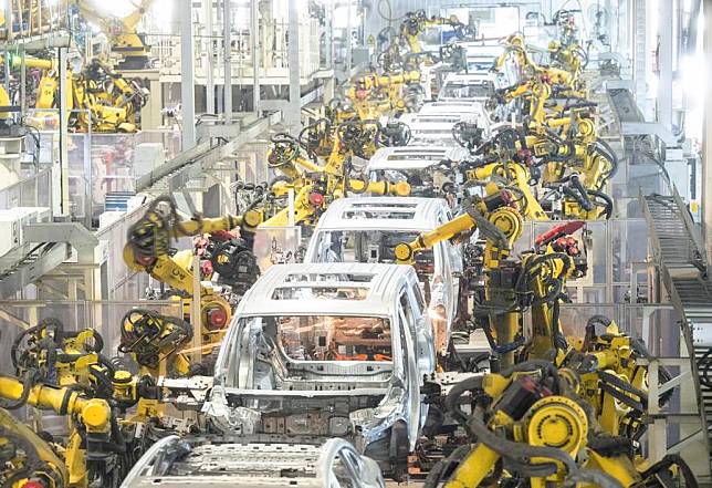Robots work at a welding workshop of Voyah, a Chinese electric auto brand, in Wuhan, central China's Hubei Province, April 1, 2024. (Xinhua/Xiao Yijiu)