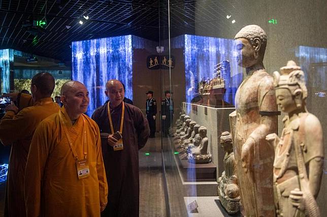 People visit an exhibition of the sixth World Buddhist Forum in Ningbo, east China's Zhejiang Province, Oct. 15, 2024. (Xinhua/Jiang Han)