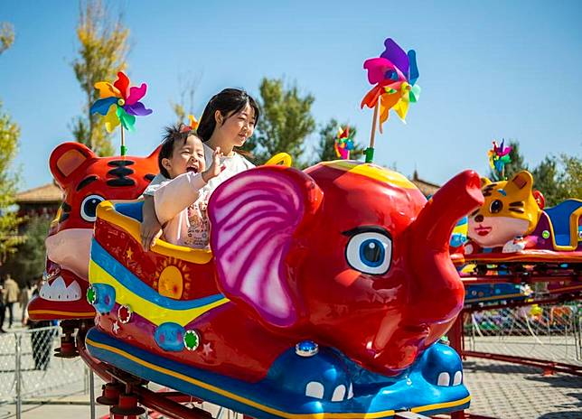 People have fun at a scenic spot in Jiuquan, northwest China's Gansu Province, Oct. 4, 2024. (Photo by Gao Hongshan/Xinhua)