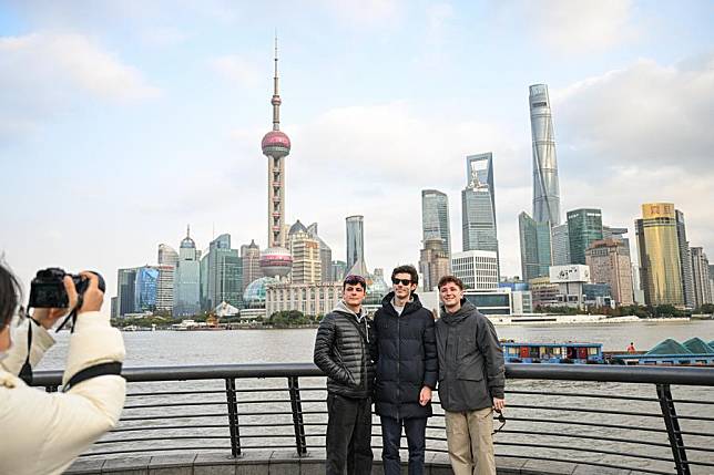 Tourists from Spain visit the Bund in east China's Shanghai, Dec. 4, 2024. (Photo by Chen Haoming/Xinhua)