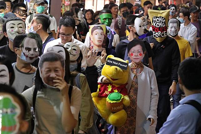 Protesters march in Causeway Bay on Halloween, on October 31, in defiance of the unpopular anti-mask law, which was hurriedly enacted under colonial-era emergency laws, a move the High Court has struck down as unconstitutional. Photo: May Tse