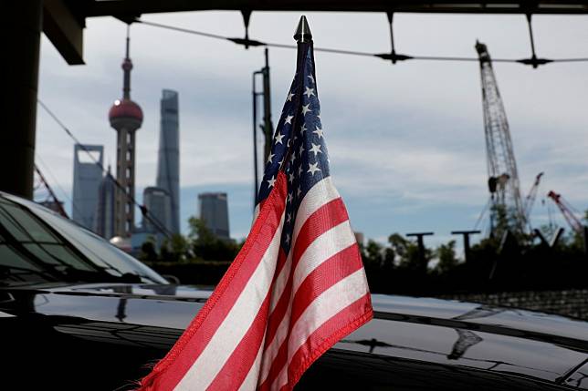 A US flag on an embassy car outside a hotel in Shanghai. The trade war will drag on private equity deals in the next 12 to 18 months, the survey found. Photo: Reuters
