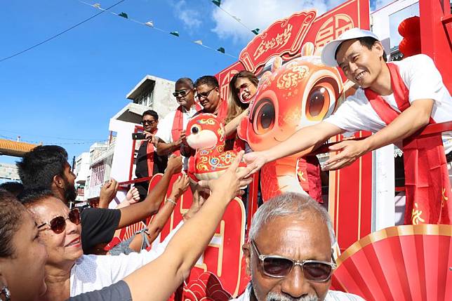 Guests on a float interact with spectators during a parade in celebration of the upcoming Spring Festival in Port Louis, Mauritius, Jan. 25, 2025. (Photo by Ally Soobye/Xinhua)