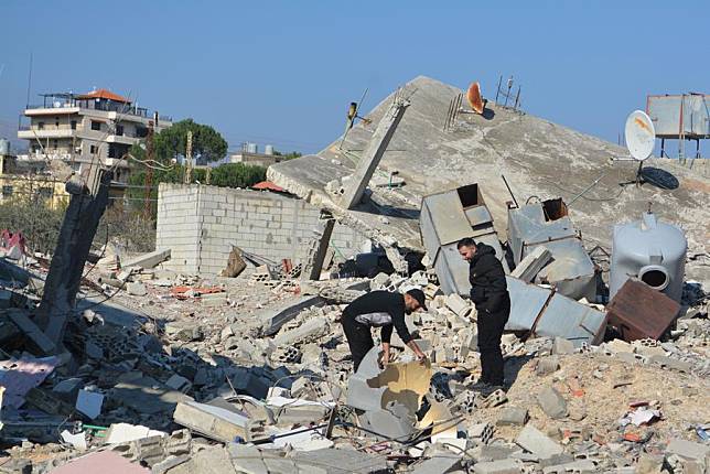 People are seen among rubble after a ceasefire between Israel and Hezbollah, in Mashghara, Lebanon, on Nov. 30, 2024. (Photo by Taher Abu Hamdan/Xinhua)