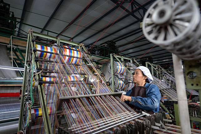 A weaver works on a loom at a plant in Qionglai city, in southwest China's Sichuan province. China's economy grew 6.1 per cent year on year in 2019, within the government's annual target of 6 to 6.5 per cent. Photo: Xinhua