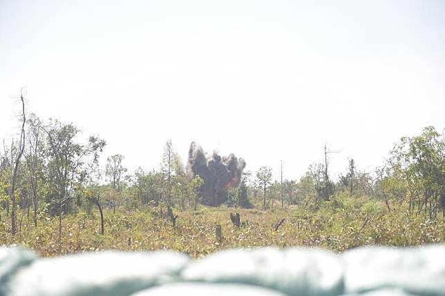 A cloud of dust and smoke rises into the sky as deminers detonate landmines with a remote control at a minefield in Siem Reap province, Cambodia, Jan. 16, 2024. (Photo by Liao Hongqing/Xinhua)