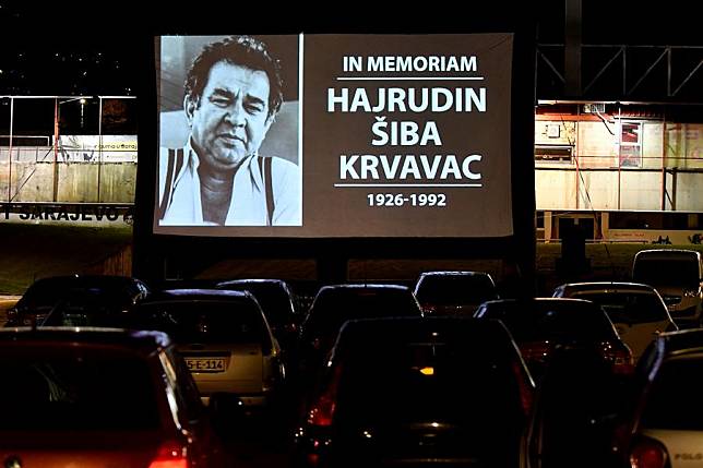 A photo of director Hajrudin Siba Krvavac is seen on the screen at the beginning of the movie Valter (Walter) Defends Sarajevo at a drive-in movie theatre in Sarajevo, Bosnia and Herzegovina (BiH) on May 6, 2022. (Photo by Nedim Grabovica/Xinhua)