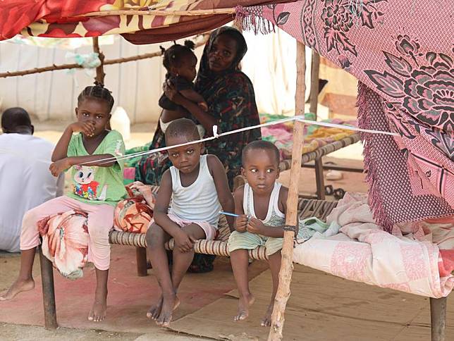 A family is seen in a tent at a center for displaced people fleeing from conflict between the Sudanese Armed Forces and the paramilitary Rapid Support Forces in Port Sudan, Red Sea State, eastern Sudan, on Nov. 12, 2024. (Xinhua/Fayez Ezaki)