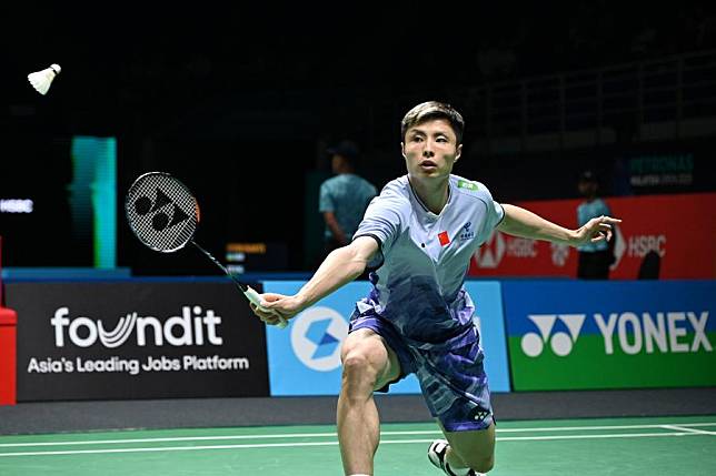 Shi Yuqi of China hits a return during the men's singles round of 32 match against Kenta Nishimoto of Japan at the Malaysia Open badminton tournament in Kuala Lumpur, Malaysia, on Jan. 7, 2025. (Photo by Chong Voon Chung/Xinhua)