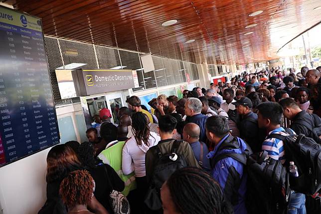 Stranded travelers are seen at the domestic departures section of the Jomo Kenyatta International Airport in Nairobi, capital of Kenya, Sept. 10, 2024. (Photo by Fred Mutune/Xinhua)