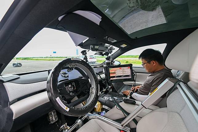 An intelligent connected vehicle tester works before a test at an enclosed test field in Tianjin, north China, June 14, 2024. (Xinhua/Sun Fanyue)