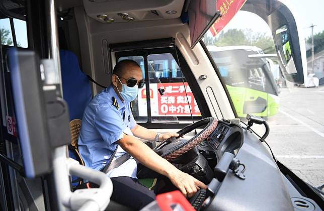 A driver prepares to start a bus at the terminal station of No. 838 Bus Line in Zhuozhou, north China's Hebei Province, on Aug. 9, 2023.