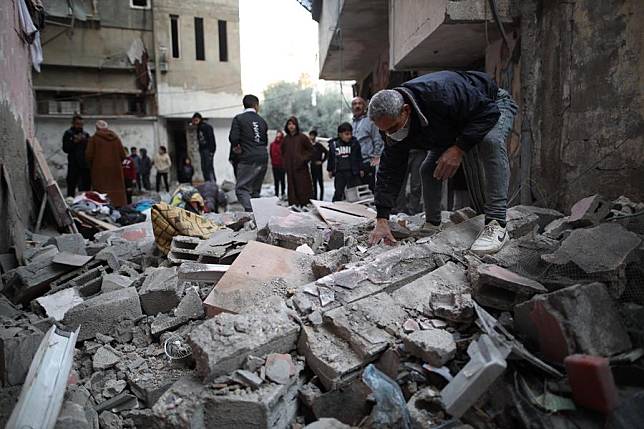 Palestinians check the site of a destroyed house after an Israeli bombardment, in the Al-Bureij refugee camp in the central Gaza Strip, on Jan. 7, 2025. (Photo by Marwan Dawood/Xinhua)