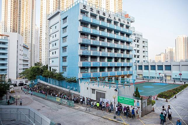 Voters stand in line in Lam Tin during the district council elections on November 24. Photo: Bloomberg