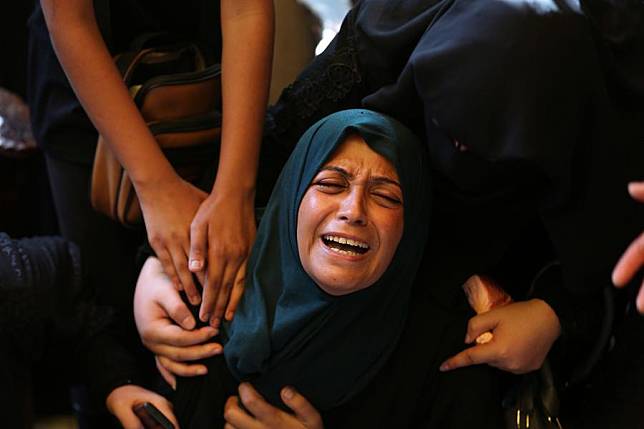 A woman mourns for victims at Nasser Hospital in the southern Gaza Strip city of Khan Younis, Aug. 13, 2024. (Photo by Khaled Omar/Xinhua)