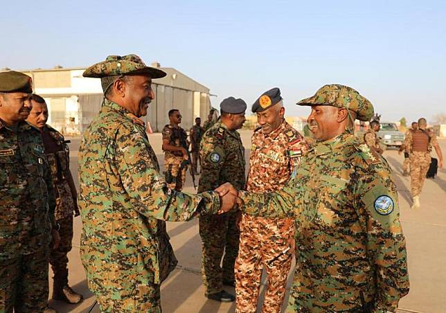 This photo provided by Sudan's Transitional Sovereign Council shows a Sudanese army officer (R, front) welcoming the General Commander of the Sudanese Armed Forces (SAF) Abdel Fattah Al-Burhan (L, front) upon his arrival in Omdurman city, northwest of Sudan's capital Khartoum, March 12, 2024. (Xinhua)