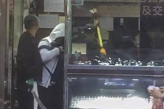 At least four masked robbers injured an employee with a knife and made off with watches in Mong Kok on Friday. Photo: Handout