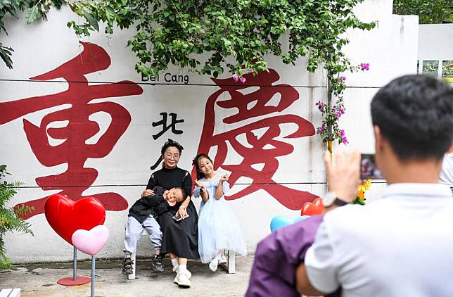 Visitors pose for a photo at the Beicang Cultural and Creative Block in Jiangbei District of southwest China's Chongqing Municipality, Oct. 4, 2024. (Xinhua/Wang Quanchao)