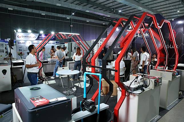 Staff members work at an exhibition booth during the Yangon International Trade Expo 2024 at the Yangon Convention Center in Yangon, Myanmar, Oct. 25, 2024. (Xinhua/Myo Kyaw Soe)