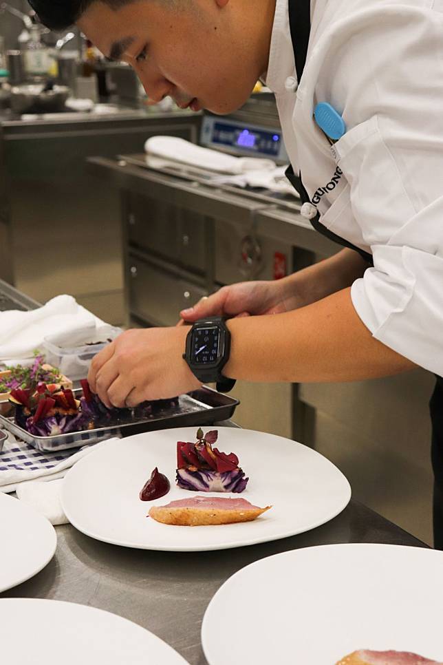 Angus Wong plating up his duck dish