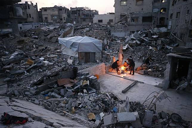 Palestinians are seen living among the rubble of destroyed houses in Jabalia in the northern Gaza Strip, Feb. 16, 2025. (Photo by Mahmoud Zaki/Xinhua)