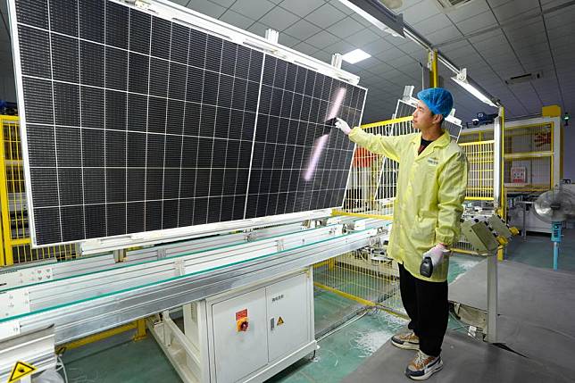 A staff member checks a photovoltaic panel at an industrial park in Tongxin County of Wuzhong, northwest China's Ningxia Hui Autonomous Region, Feb. 20, 2025. (Xinhua/Yang Zhisen)