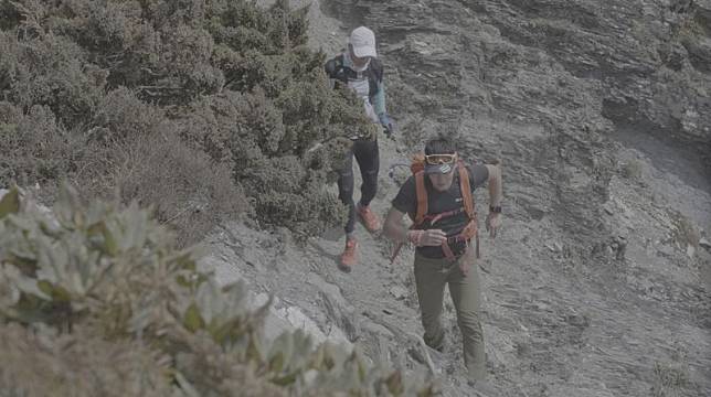 周青（前）與古明政（後）在卡羅樓斷崖的陡峭地形奔跑鍛練體能。（活水文化提供）