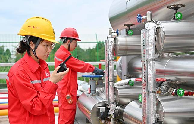 Technicians carry out equipment maintenance at a well of the Fuling shale gas field in Zhongxian County, southwest China's Chongqing, Sept. 19, 2023. (Xinhua/Wang Quanchao)