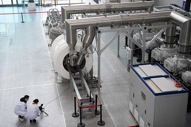 Scientific research personnel record the running state of a linear plasma generator in Hefei, east China's Anhui Province, Jan. 14, 2025. (Xinhua)