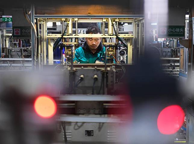 A staff member processes motor parts at Zhejiang Jiuzhou New Energy Technology Co., Ltd. in Wenling, Taizhou, east China's Zhejiang Province, Feb. 29, 2024. (Xinhua/Weng Xinyang)