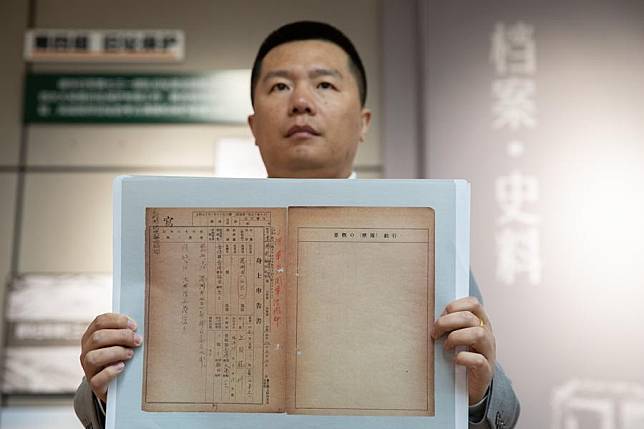 A researcher displays the copy of a document containing detailed information about military personnel from Unit 731, a Japanese germ warfare unit during World War II, at the Exhibition Hall of Evidences of Crime Committed by Unit 731 of the Japanese Imperial Army in Harbin, capital of northeast China's Heilongjiang Province, on April 29, 2024. (Xinhua/Zhang Tao)