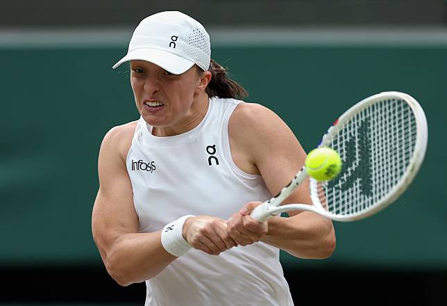 Iga Swiatek of Poland hits a return during the women's singles third round match against Yulia Putintseva of Kazakhstan at Wimbledon tennis Championship in London, Britain on July 6, 2024. (Xinhua/Han Yan)