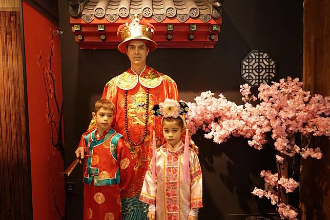 People in traditional Chinese costumes pose for a group photo during Chinese New Year celebrations in Hollywood's Ovation Mall, California, the United States, on Jan. 26, 2025.