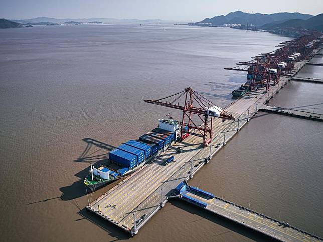 This aerial drone photo shows Kawa Ningbo, the first cargo ship that will sail on the Ningbo-Wilhelmshaven direct route, docking at Ningbo Zhoushan Port in Ningbo, east China's Zhejiang Province, Dec. 30, 2024. (Xinhua/Jiang Han)