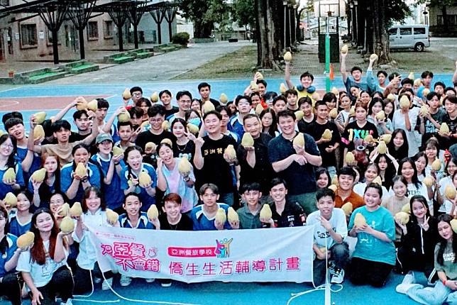 亞洲餐旅僑生拿到麻豆果農沈鉦凱贈送的文旦好開心。（亞洲餐旅提供）