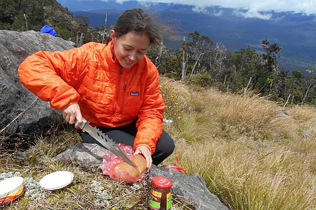 Hong Kong-born Sophie Cairns on a lunch break during the 35-kilometre hike in to the base camp for an ascent of Mount Giluwe, Papua New Guinea, the highest volcano in Oceania.