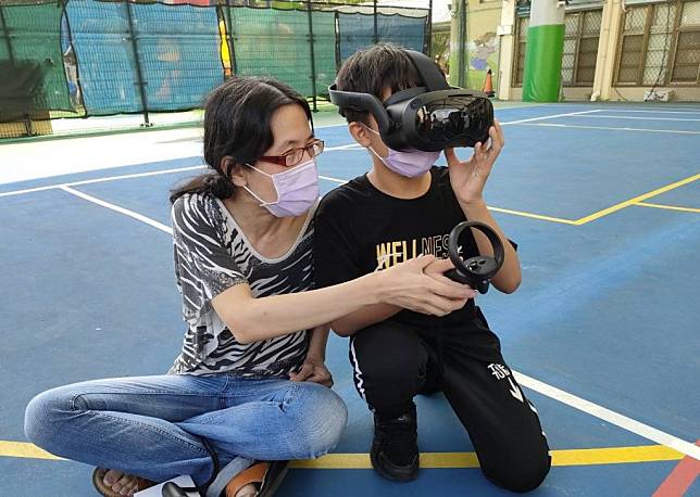 雨聲國小教學，推廣老師細心教導學生VR頭盔的介面及使用方式，小朋友們紛紛表示實在太酷了。（北市教育局提供）