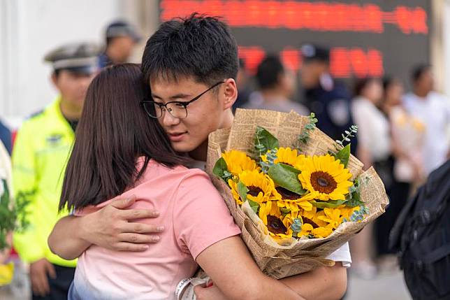 A student hugs his mother after the exam at a national college entrance examination site in Dali Bai Autonomous Prefecture, southwest China's Yunnan Province, June 8, 2024. (Photo by Luo Xincai/Xinhua)