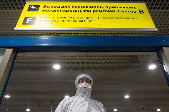 A health worker wearing a protective suit at Sheremetyevo International Airport OAO in Moscow, Russia. Photo: Bloomberg