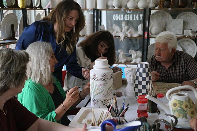 Turkish ceramist Duygu Kavukcu (3rd L) instructs her students, who are suffering from various health issues, how to mold clay and make ceramic objects in a studio in Ankara, Türkiye, on May 22, 2024. (Mustafa Kaya/Handout via Xinhua)