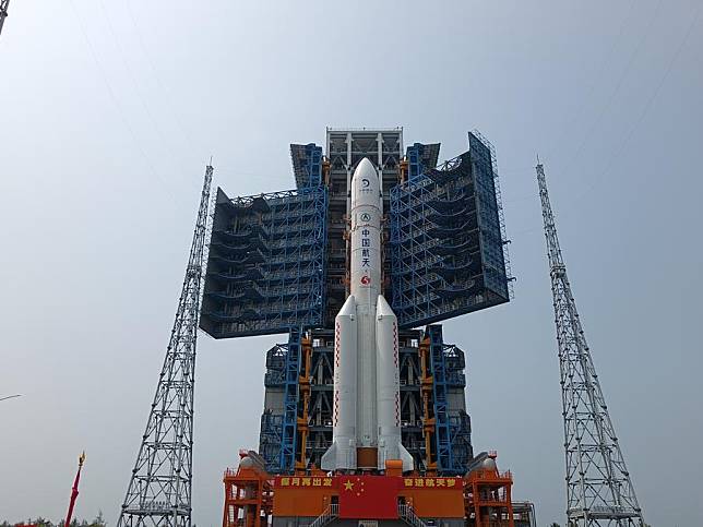 This photo taken on April 27, 2024 shows the combination of the Chang'e-6 lunar probe and the Long March-5 Y8 carrier rocket having been transferred vertically to the launching area at the Wenchang Space Launch Center in south China's Hainan Province. (Photo by Huang Guochang/Xinhua)